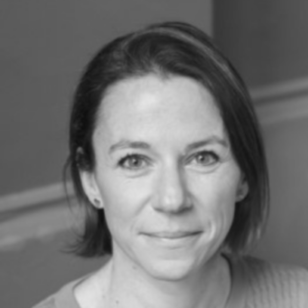 Ashden team member, Alex Green smiling in black and white