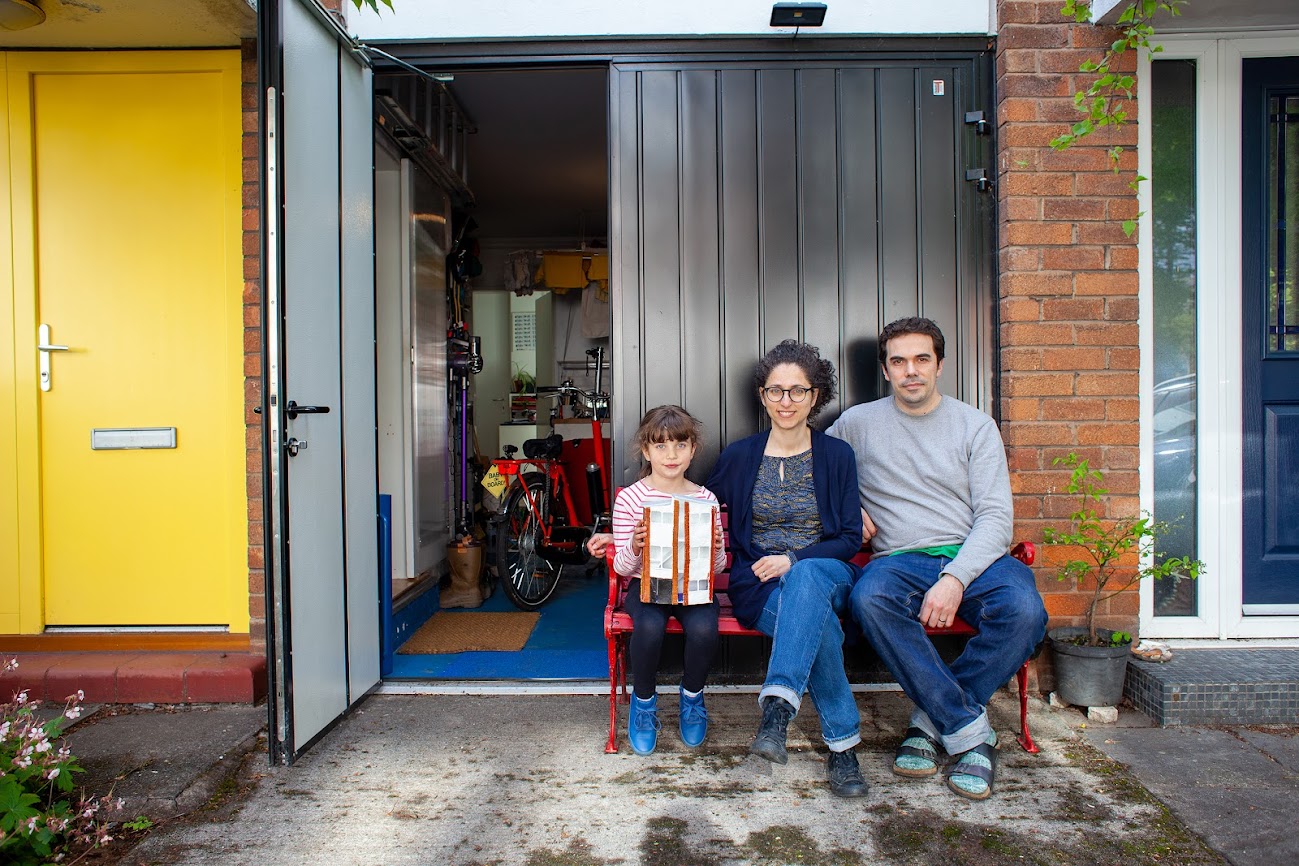 A family sitting on steps on a house
