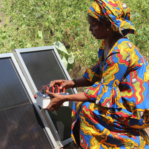 A woman working on solar panels